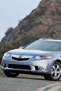 Превью обои acura, tsx, 2010, голубой, вид спереди, стиль, авто, акура, кустарники, скала, небо, асфальт