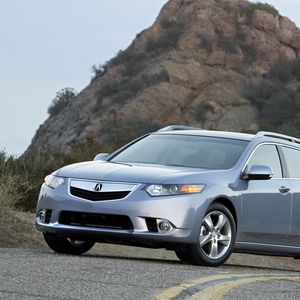 Превью обои acura, tsx, 2010, голубой, вид спереди, стиль, авто, акура, кустарники, скала, небо, асфальт