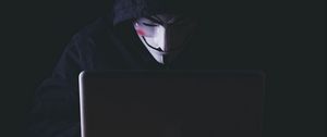Превью обои аноним, хакер, маска, капюшон, ноутбук, темный