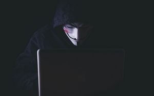 Превью обои аноним, хакер, маска, капюшон, ноутбук, темный