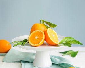 Превью обои апельсины, дольки, листья, фрукт, цитрус