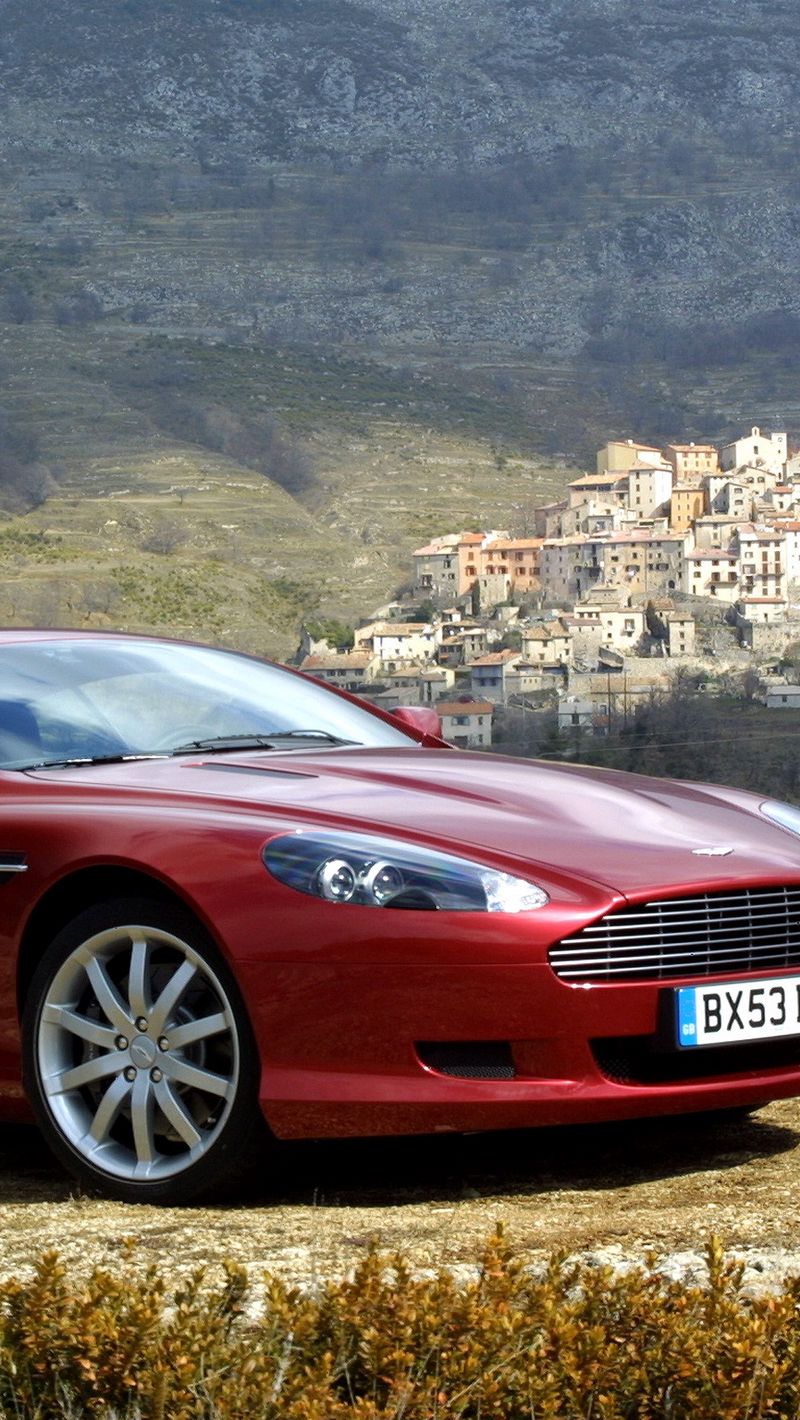 Скачать 800x1420 aston martin, db9, 2004, красный, вид сбоку, стиль, астон  мартин, авто, природа, деревья, дома обои, картинки iphone se/5s/5c/5 for  parallax