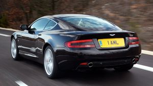 Превью обои aston martin, db9, 2006, черный, вид сзади, стиль, авто, скорость, природа, деревья