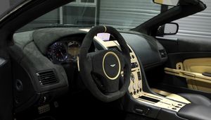 Превью обои aston martin, db9, 2009, черный, салон, интерьер, руль, спидометр