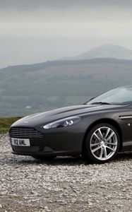 Превью обои aston martin, db9, 2010, черный, вид сбоку, стиль, авто, астон мартин, спорт, природа, горы