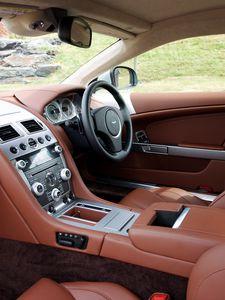 Превью обои aston martin, db9, 2010, коричневый, салон, интерьер, руль, спидометр, кожа