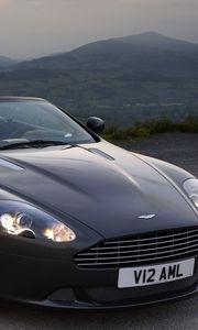 Превью обои aston martin, db9, 2010, черный, вид спереди, стиль, авто, астон мартин, горы