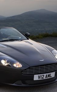 Превью обои aston martin, db9, 2010, черный, вид спереди, стиль, авто, астон мартин, горы