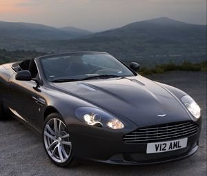 Превью обои aston martin, db9, 2010, черный, вид спереди, стиль, авто, астон мартин, горы