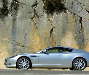 Превью обои aston martin, db9, серебряный металлик, вид сбоку, стиль, авто, скала