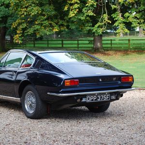 Превью обои aston martin, dbs, 1967, синий, вид сзади, авто, астон мартин, трава, деревья