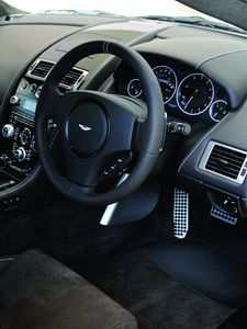 Превью обои aston martin, dbs, 2010, черный, салон, интерьер, руль, спидометр