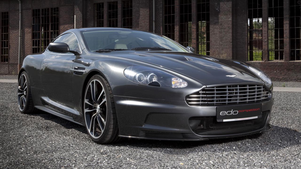 Обои aston martin, dbs, 2010, серый металлик, вид спереди, астон мартин, авто, здание