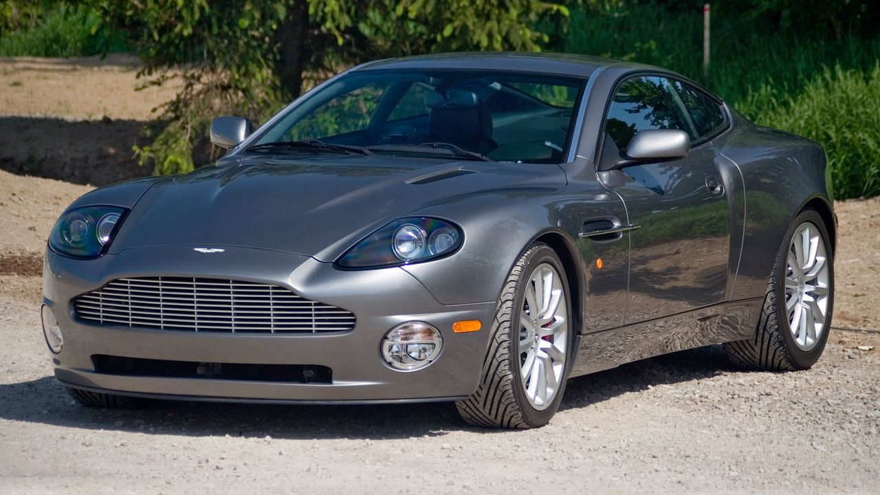 Обои aston martin, v12, vanquish, 2001, серый, вид спереди, астон мартин, трава