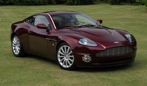 Превью обои aston martin, v12, vanquish, 2001, бордовый, вид сбоку, стиль, астон мартин, трава