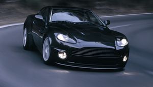 Превью обои aston martin, v12, vanquish, 2004, черный, вид спереди, астон мартин, асфальт