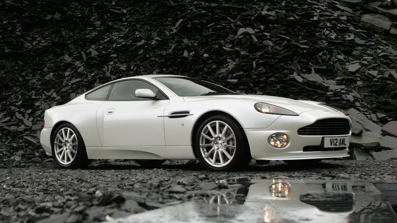 Обои aston martin, v12, vanquish, 2004, белый, вид сбоку, астон мартин, отражение