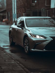 Превью обои автомобиль, серый, фара, дорога, вид спереди