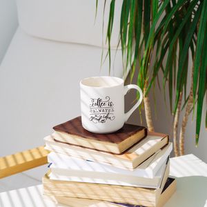 Превью обои чашка, надпись, книги, растение, тень