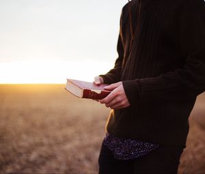 Превью обои человек, книга, поле, солнечный свет