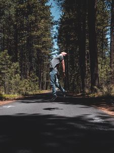 Превью обои человек, прыжок, левитация, дорога, деревья, лес