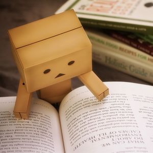 Превью обои danbo, картонный робот, книга, чтение