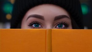 Превью обои девушка, книга, взгляд, глаза, лицо
