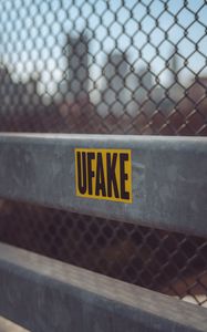 Превью обои fake, наклейка, надпись, забор, сетка