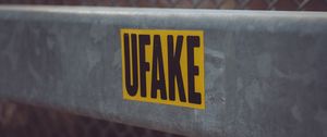 Превью обои fake, наклейка, надпись, забор, сетка