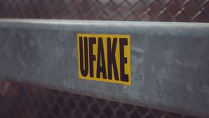 Превью обои fake, наклейка, надпись, забор, сетка
