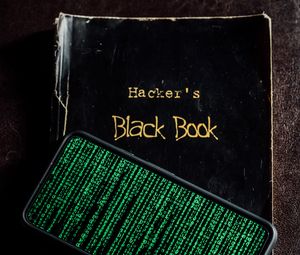 Превью обои хакер, книга, телефон, матрица