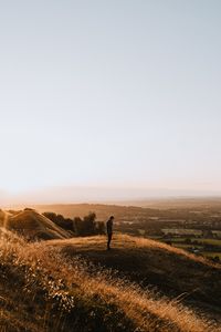 Превью обои холмы, человек, силуэт, закат, пейзаж