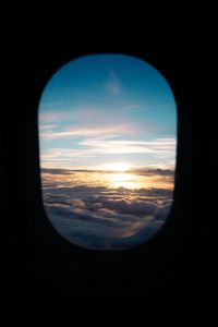 Превью обои иллюминатор, облака, закат, черный