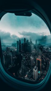 Превью обои иллюминатор, окно, город, вид сверху