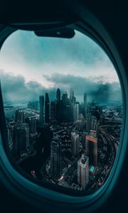 Превью обои иллюминатор, окно, город, вид сверху