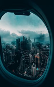 Превью обои иллюминатор, окно, город, вид сверху