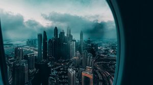 Превью обои иллюминатор, окно, город, вид сверху