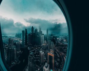 Превью обои иллюминатор, окно, город, вид сверху