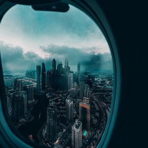 Превью обои иллюминатор, окно, город, вид сверху