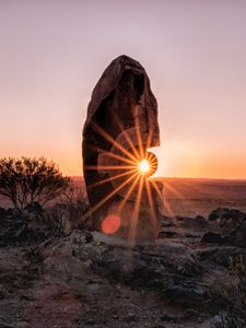 Превью обои камень, скала, солнце, солнечные лучи, закат