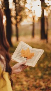 Превью обои книга, листок, рука, осень, размытость