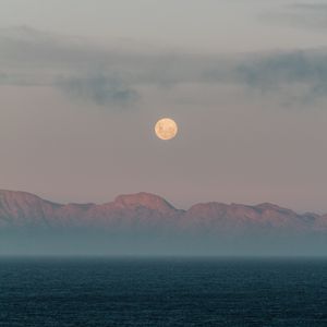 Превью обои луна, горы, туман, море, вечер