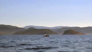 Превью обои море, лодка, вода, остров, холмы