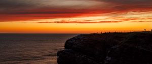 Превью обои море, скала, закат, небо, темный, природа