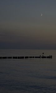 Превью обои море, сваи, ночь, луна, небо
