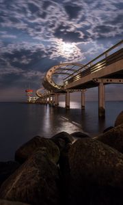 Превью обои мост, арки, сваи, море, камни, сумерки