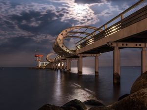 Превью обои мост, арки, сваи, море, камни, сумерки