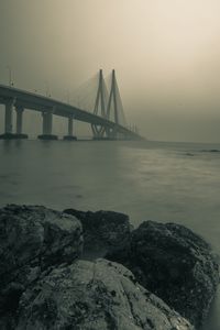 Превью обои мост, камни, туман, море, черно-белый