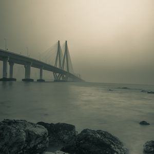 Превью обои мост, камни, туман, море, черно-белый