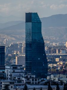 Превью обои небоскреб, здания, горы, город